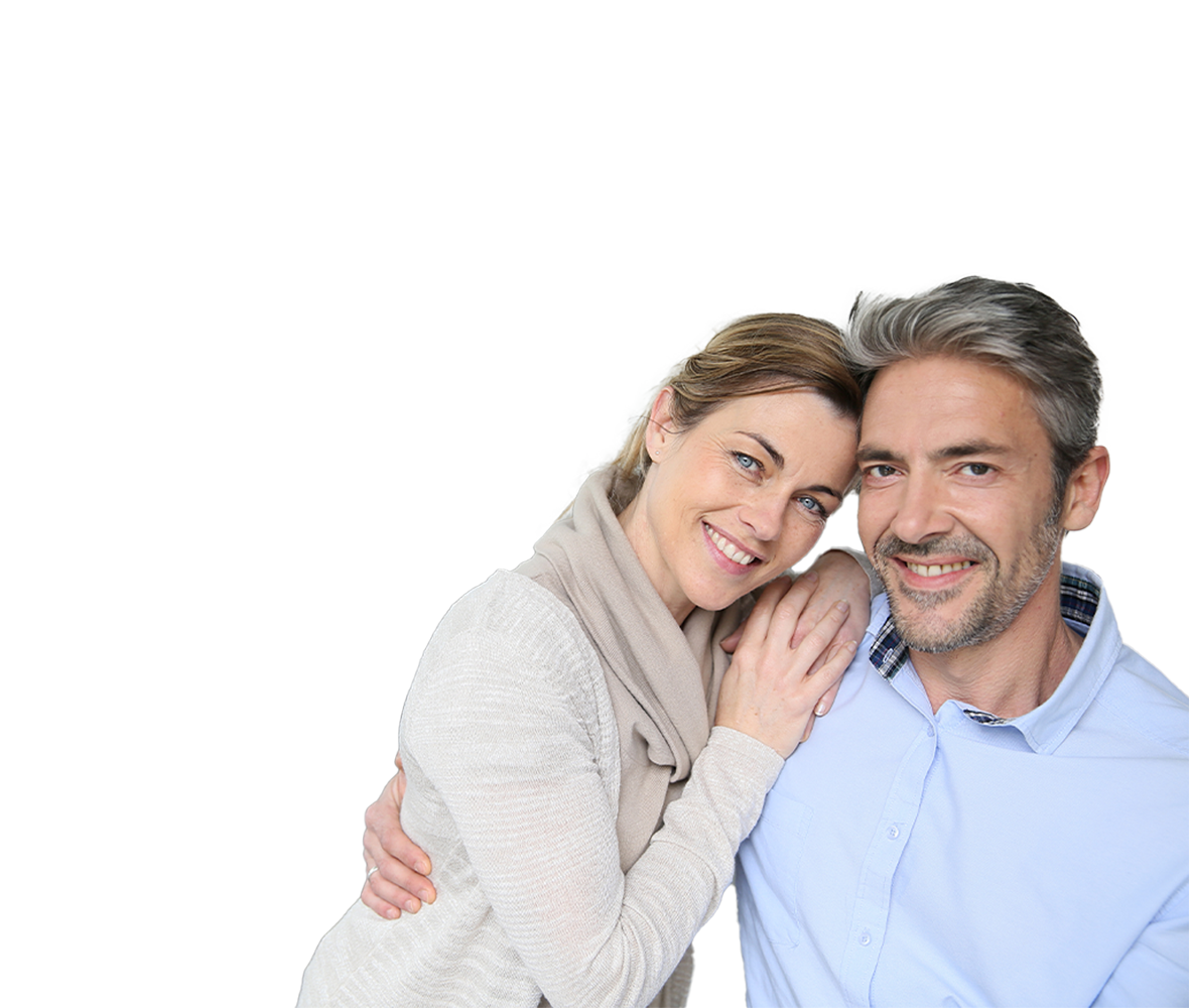 The image shows a man and a woman standing close together, smiling at the camera.